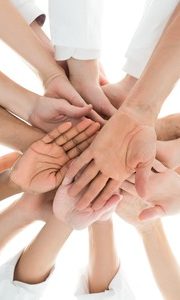 48645177 - directly below shot of medical team piling hands against white background